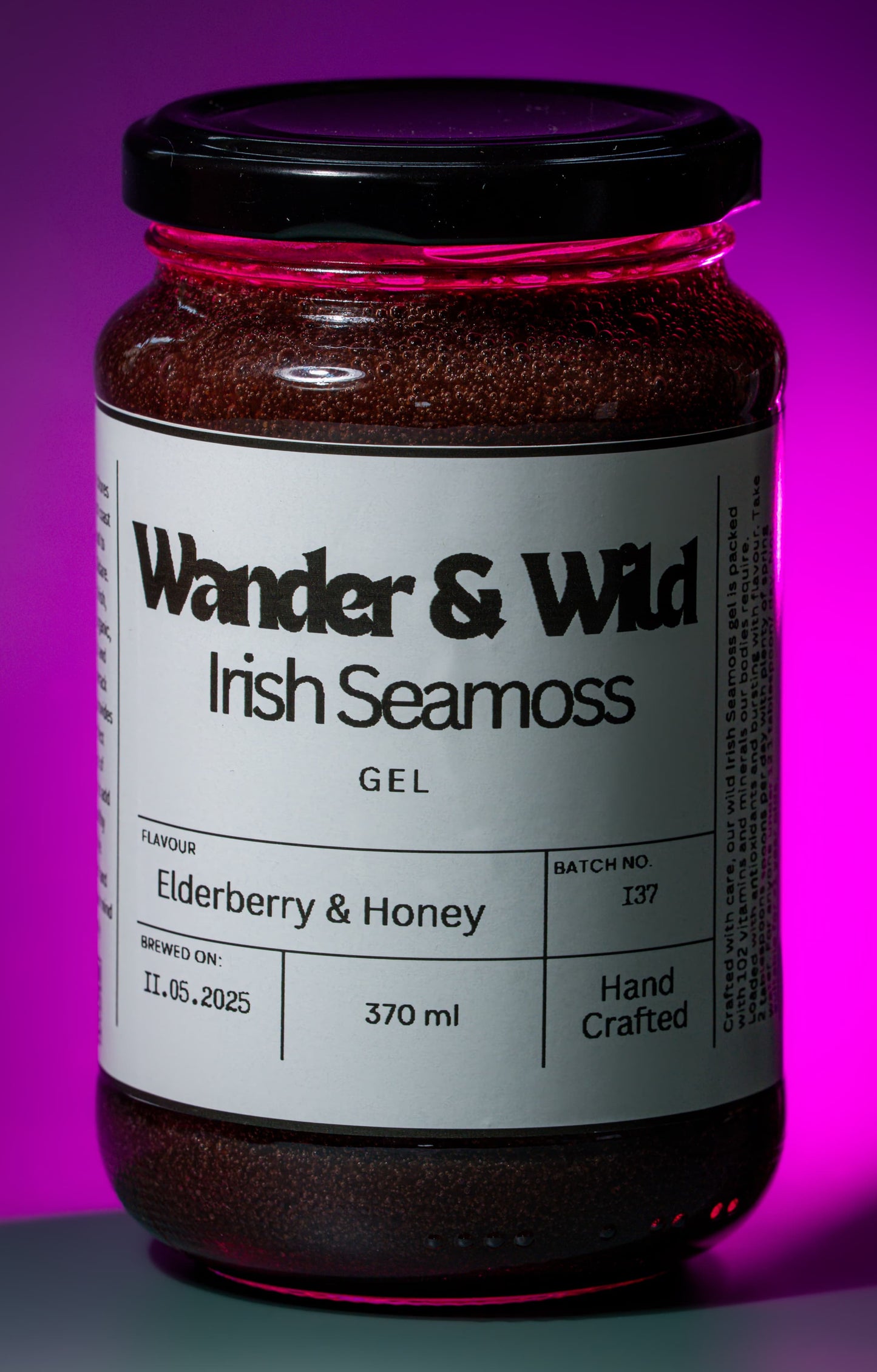 Jar of Wander & Wild Irish Seamoss Gel with a purple gradient background